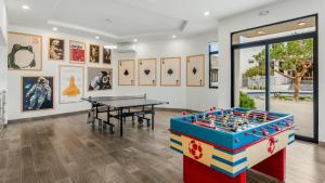 a ping pong table in a room with a ping pong ball at Modern Condo with Stunning Bay Views in Cabo San Lucas