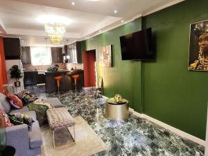a living room with a couch and a flat screen tv at Hilltop Villa Chez Coco in Rodney Bay Village