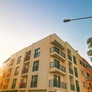 an apartment building with balconies and a street light at Elegant Ephesus Suites - Hadrian in Selçuk