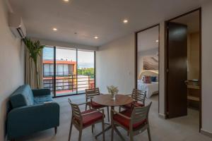 a living room with a table and chairs and a bedroom at The Retreat at Sisal in Sisal