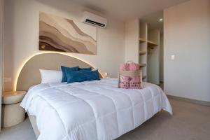 a bedroom with a white bed and a painting on the wall at The Retreat at Sisal in Sisal +35 photos