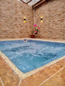 ein großes Schwimmbecken in einer Backsteinmauer mit zwei Lampen in der Unterkunft Suite San Vicente 1 Jacuzzi Cocina Parqueo in Juivi