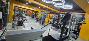 a gym with treadmills and machines in a room at Hotel gym club33 in Huancayo