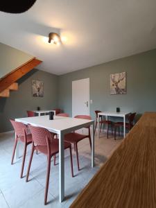a dining room with white tables and red chairs at Le Rêve de Poulaines - Camping Naturiste 1 JUIN - 30 SEPTEMBRE et chambres d'hôtes TOUTE L'ANNÉE in Poulaines