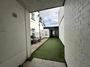 an empty hallway of a building with a green lawn at One bed Mews House in Northwood