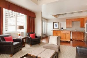 a living room with chairs and a table and a kitchen at Executive Hotel Vintage Court in San Francisco