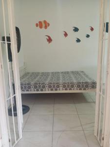 a bed in a room with butterfly stickers on the wall at Chalés Boraceia Duda in Boracéia +36 photos