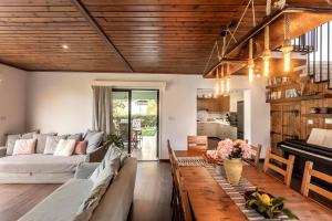 a living room with a couch and a table at Maison du Mont in Kalopanayiotis