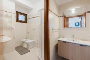 a bathroom with a sink toilet and a mirror at Ciciliana in Valderice +30 photos