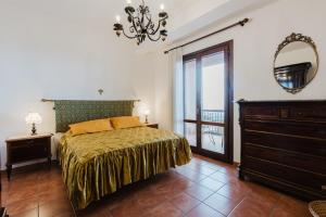 a bedroom with a bed and a dresser and a mirror at Ciciliana in Valderice