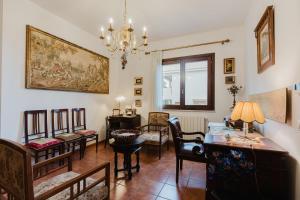 a living room with chairs and a table and a chandelier at Ciciliana in Valderice
