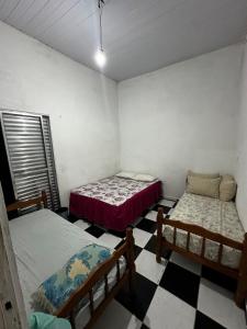 Ένα ή περισσότερα κρεβάτια σε δωμάτιο στο Casa na Praia veraneio fim de semana e temporada