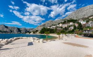 a beach in front of a mountain at Apartment Protrka in Omiš