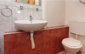 a bathroom with a sink and a toilet at Apartment Protrka in Omiš