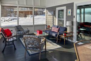 a screened in porch with chairs and a couch at half Mi to Song Mountain Resort Ski Getaway! in Tully