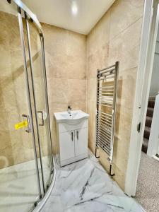 a bathroom with a sink and a shower at Spacious 5-Bed House in Chigwell - Grange Hill in Chigwell