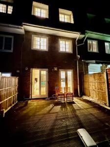 a patio with two chairs and a building at Spacious 5-Bed House in Chigwell - Grange Hill in Chigwell