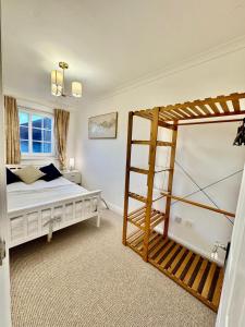 a bedroom with a bunk bed and a ladder at Spacious 5-Bed House in Chigwell - Grange Hill in Chigwell