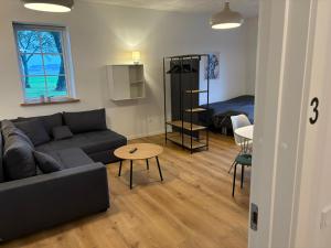 a living room with a couch and a table at Kildebakkegaard Bed and Breakfast in Nørager