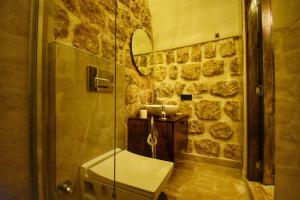 a bathroom with a shower and a sink at Mara Loya Konağı in Mardin