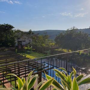 a view of a pool with benches and a fence at Casa Canto do Bem-te-vi in Lençóis