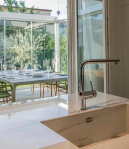 a kitchen with a sink and a table and a window at Villa JD in Forte dei Marmi