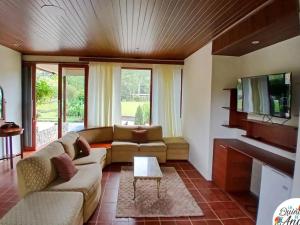 a living room with a couch and a tv at La Quinta de Andrés in San Isidro