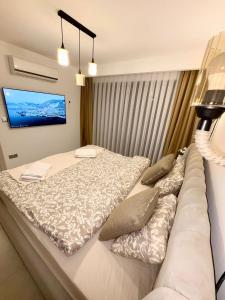 a bedroom with a large bed and a tv on the wall at 3 bedrooms villa with own pool! in Pano Dheftera +59 photos