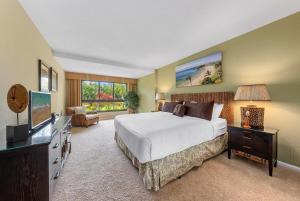 a large bedroom with a bed and a television at Kaanapali Alii 411 · ALII 411 Ground Floor 2BD at OceanFront Res in Lahaina +47 photos