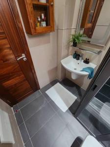 a small bathroom with a sink and a toilet at La Trêve Sacrée - Dakar mermoz sacrée cœur in Dakar