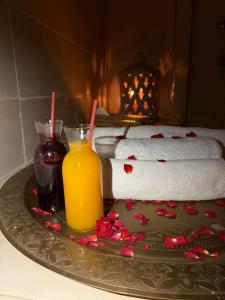 a tray with two glasses of orange juice and towels at Domaine JJ in Marrakech +10 photos