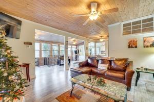 a living room with a couch and a christmas tree at Hot Tub, Trails, Views! Little River Retreat in Sunshine