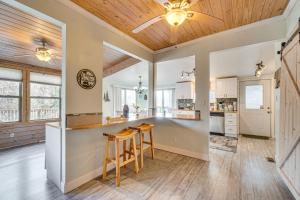 a kitchen with wooden ceilings and a bar with stools at Hot Tub, Trails, Views! Little River Retreat in Sunshine