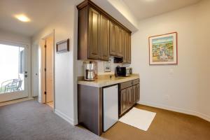 a kitchen with wooden cabinets and a counter top at Stunning 360 Ocean Views, Near Redwoods NP! in Smith River