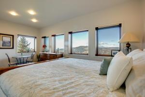 a bedroom with a large bed with large windows at Stunning 360 Ocean Views, Near Redwoods NP! in Smith River