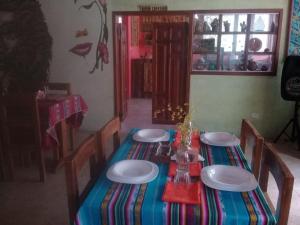 a table with chairs and plates on top of it at El Nido del Condor Hostel Baeza in Baeza