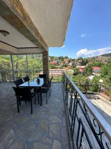 a patio with a table and chairs on a balcony at Kokkotis Residence in Samarina +16 photos