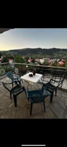 a table and chairs on top of a balcony at Kokkotis Residence in Samarina