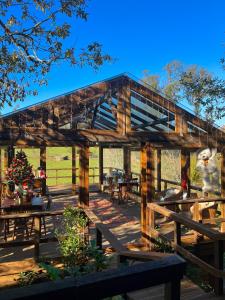a wooden pavilion with picnic tables and benches at Casa Da Avó - Vale da Silva Villas in Albergaria-a-Velha
