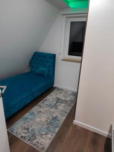 a blue couch in a room with a window at Vila Dunja Pale in Pale