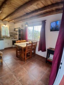 een keuken en eetkamer met een tafel en stoelen bij La Chakana in Capilla del Monte