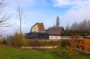 a large building in the middle of a field at Planinska Kraljica in Gornje Pale