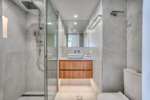 a bathroom with a sink and a shower at Talisman Beachside in Gold Coast +34 photos