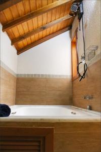 a bathroom with a bath tub in a room at GramadoPenthouse 4quartos 3banheiros in Gramado +27 photos