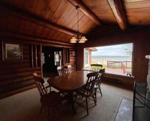 a dining room with a table and chairs and a window at Lakeside Lodge in Saint Ignace