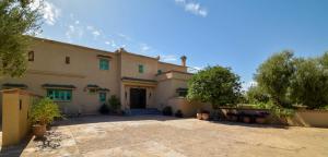 a large house with a driveway in front of it at Bluegreen Guest House Marrakech in Aït Amara