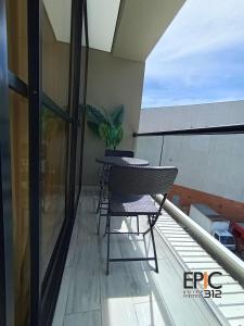 a balcony with a table and a plant on it at Epic Suite 312 Deluxe Airport in Cuba