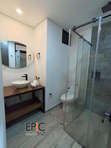 a bathroom with a sink and a glass shower at Epic Suite 312 Deluxe Airport in Cuba