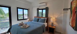 a bedroom with a bed with towels on it at Lickety Split Unit 3, Northside Ocean View in Caye Caulker