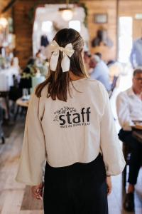 a woman wearing a shirt with a bow on her back at Vale da Silva Villas - Homes in Albergaria-a-Velha